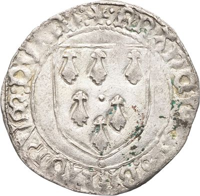 une pièce d'argent sur laquelle figurent des armoiries
