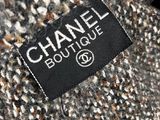 the label on the back of a chanel coat is black and white