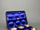 silver plated bowls in a blue velvet case on a gray surface