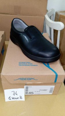 a box with a pair of black shoes on top of it