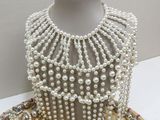 a mannequin with a lot of jewelry on it
