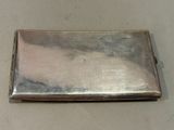 silver metal business card case sitting on top of a white table