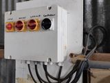 a white electrical box with a red light on it