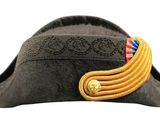 a black hat with a gold ribbon on it