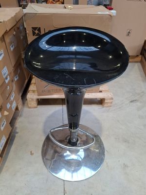an image of a black stool in a warehouse