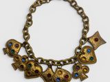a close up of a gold bracelet with owls on it