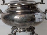 a silver plate with a lid on a stand