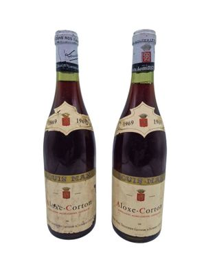 two bottles of wine are sitting next to each other on a white surface