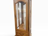 an image of a wooden display cabinet with a glass door