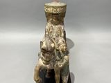 an image of a statue of a man riding a horse with a hat on his head