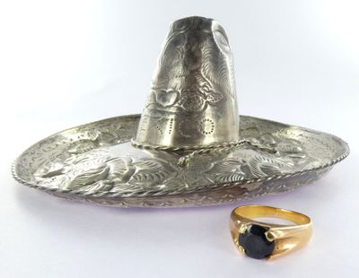 a silver sombren with a black stone in it