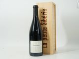 a bottle of wine sitting next to a wooden box