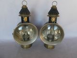 pair of antique brass and black lamps on a white background