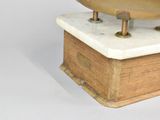 a gold bowl on a marble base on a white background
