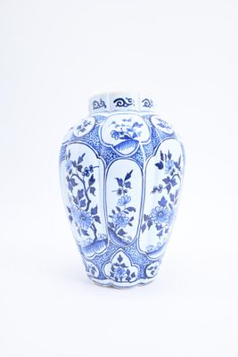 a blue and white vase sitting on a white surface
