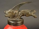 a red fire extinguisor with a dragon head on it