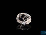 a white diamond on a black surface with a black background