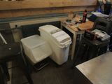 two trash cans sitting next to each other in a room