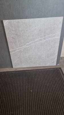un tapis noir posé par terre près d'une porte