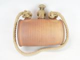 rope wrapped around a clay pot with two sheep on top
