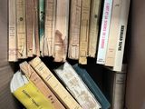 a box full of books that are sitting on the floor