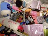 a pile of cosmetics and other beauty products on top of a table