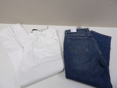 two pairs of white and blue jeans on a white table