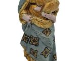 figurine of the virgin and child on a wooden base