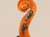 a close up of a violin ' s neck with a fiddle in the background
