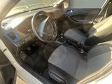 the interior of a car with the door open and the driver ' s seat down
