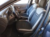the interior of a car with a blue seat cover and a steering wheel