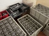 many containers of silverware sitting on the floor