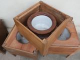 a wooden box with a bowl on top of it