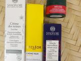 the contents of the skin care products are laid out on a bamboo mat