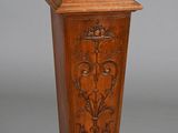 two tall wooden pedestals with carvings on them