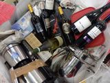 many bottles of wine sitting in a basket on the floor