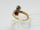 a gold ring with a ruby stone in the middle of it