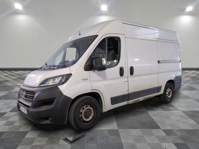 the white van is parked on a checkered floor in a room