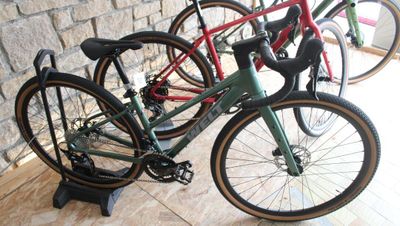 three bikes that are sitting on a stand next to each other