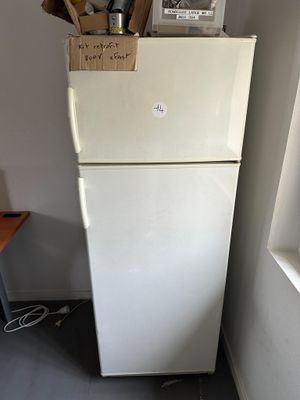 un réfrigérateur sur lequel est posée une affiche, dans une cuisine