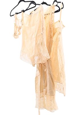three dresses hanging on a clothes rack on a white background