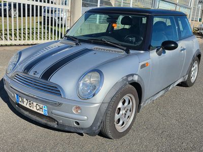a small silver car parked in a parking lot