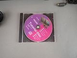a cd that is sitting on a table next to a mouse