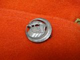 a silver coin with a helmet on it sitting on a red cloth