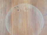 a wooden table with a circular design on it