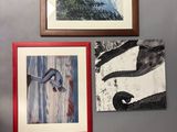 many pictures hanging on the wall of this room