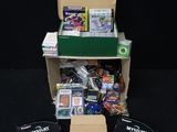 the contents of a box of games are sitting on a black surface