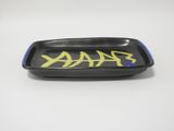black and blue ceramic dish with yellow writing on it