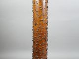 an image of a tall wooden lamp with a metal base
