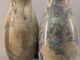 two vases sitting next to each other on a table